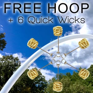 May include: Image features a white hoop and six quick wicks against a blue sky with clouds and trees. The text "FREE HOOP + 6 Quick Wicks" is displayed at the top. The wicks are attached to metal rings.