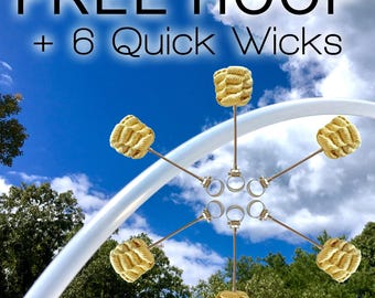 May include: Image features a white hoop and six quick wicks against a blue sky with clouds and trees. The text "FREE HOOP + 6 Quick Wicks" is displayed at the top. The wicks are attached to metal rings.