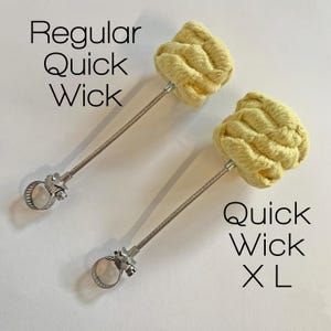 May include: Two fire starters, one labeled "Regular Quick Wick" and the other labeled "Quick Wick XL". Both are yellow and made of braided rope attached to a metal rod with a clamp.