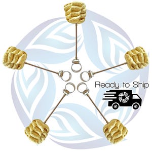May include: Five fire poi arranged in a star shape. Each poi features a woven, beige head attached to a metal rod with a silver clamp. The image includes the text "Ready to Ship" and a graphic of a delivery truck.