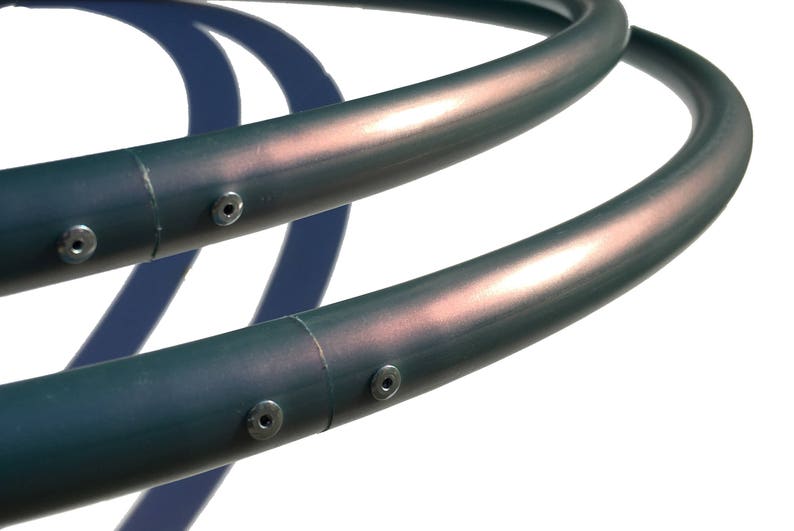 May include: Two dark green metal hoops with silver accents. The hoops are stacked on top of each other.