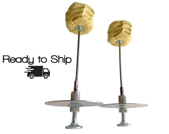 May include: Two fire poi props featuring cream-colored woven wicks attached to thin metal stems. Each prop includes a circular metal hand guard and a threaded base. The text Ready to Ship and a truck icon are visible to the left of the props.