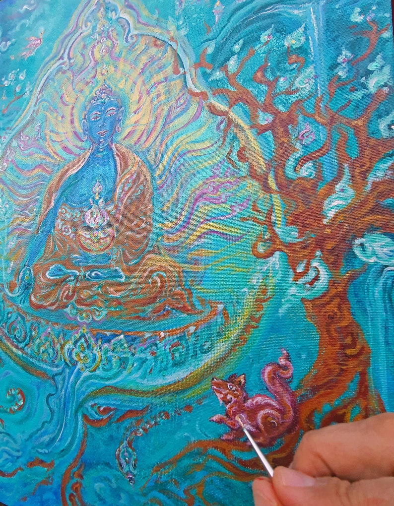 May include: A painting in progress of a blue Buddha figure sitting in a meditative pose with a golden halo. The Buddha is surrounded by swirling blue and gold patterns. A small pink animal is being painted on the right side of the canvas.