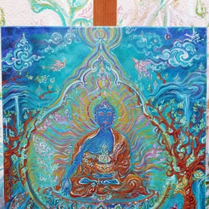 May include: A blue Buddha painting with intricate details. The Buddha is seated in a meditative pose with a golden halo and surrounded by swirling patterns. The background is a vibrant blue with hints of green and gold.