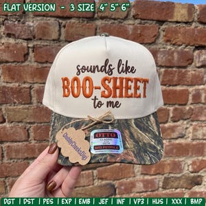 Puede incluir: Una gorra de béisbol de color crema con una visera de patrón de camuflaje. La parte frontal presenta un texto bordado en marrón y naranja que dice "sounds like BOO-SHEET to me". Una etiqueta de papel marrón está atada a la visera.