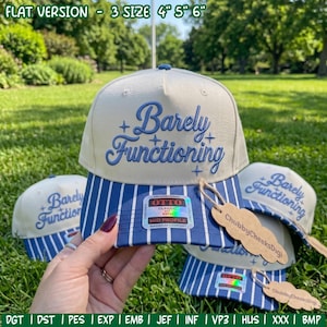 May include: A cream-colored baseball cap with blue pinstripes on the brim and the text Barely Functioning embroidered in blue on the front. The cap features a holographic Otto sticker on the brim and a brown paper tag labeled ChubbyCheeksDigi.