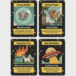 Four illustrated oracle cards displayed in a grid on a light background. The cards feature playful cartoon-style artwork with titles and messages, including an elephant in an energy bubble, a dragon taking a leap, a dumpster fire scene, and a UFO abducting a character. Each card has a black border with star accents and a whimsical, humorous design style.