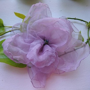 Giant purple fabric flower pin.