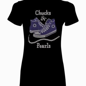 May include: Black t-shirt with a rhinestone design of a pair of blue sneakers and a pearl necklace. The text "Chucks & Pearls" is also included in rhinestones.