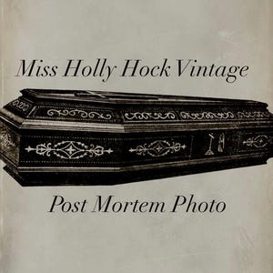 May include: A black wooden coffin with ornate carvings and a cross on top. The text "Miss Holly Hock Vintage Post Mortem Photo" is printed below the coffin.