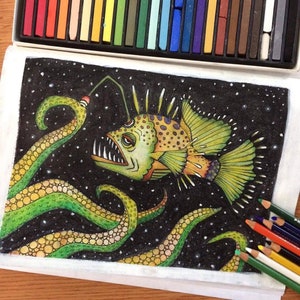 An example of a coloring book page that was colored using chalk pastels and colored pencils. Image of an angler fish and octopus tentacles colored in orange green and purple on a black speckled background