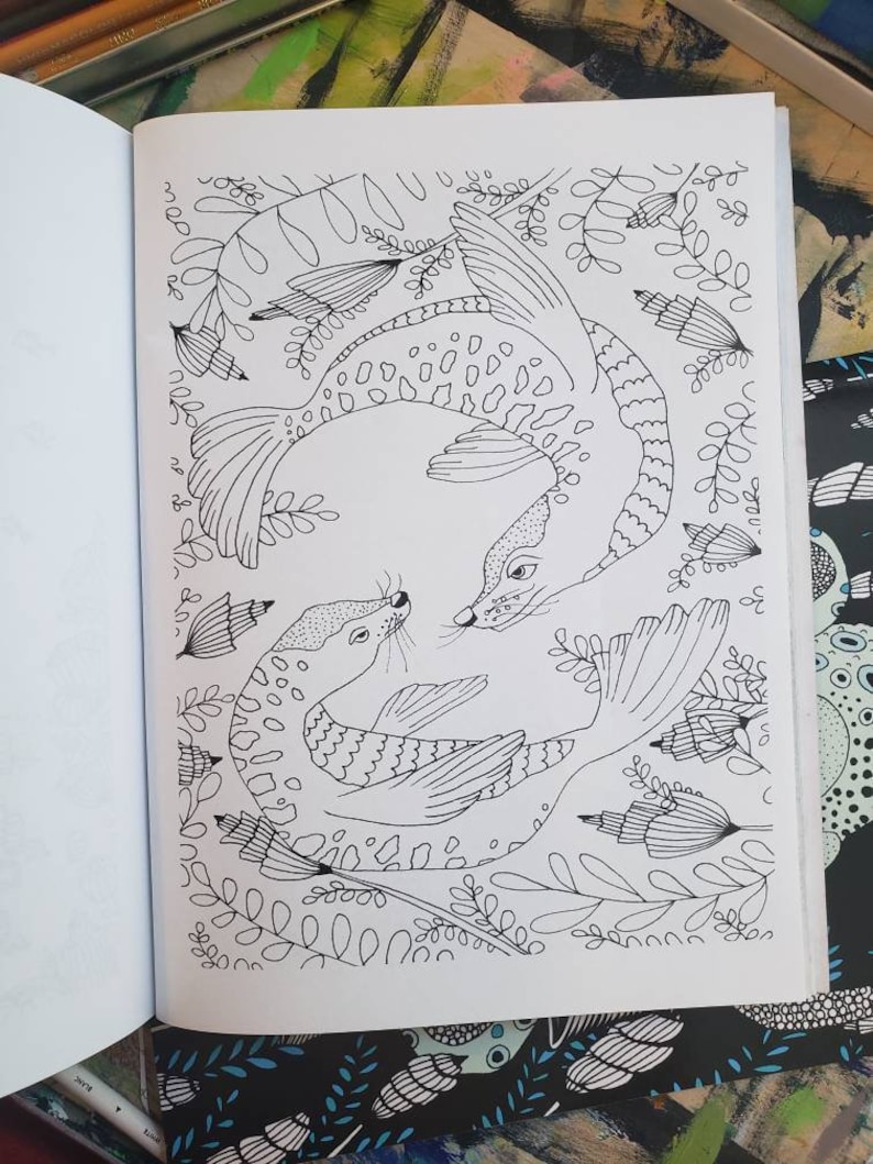 a black and white coloring page illustration of two sea lions swimming in a circle together and looking at each other as they are surrounded by sea vegetation