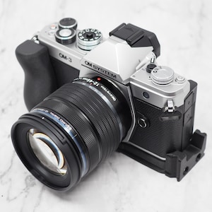 OM Systems OM-3 Carbon Fiber L Grip Arca Swiss Airtag (Grip Only, Camera and Lens NOT Included)