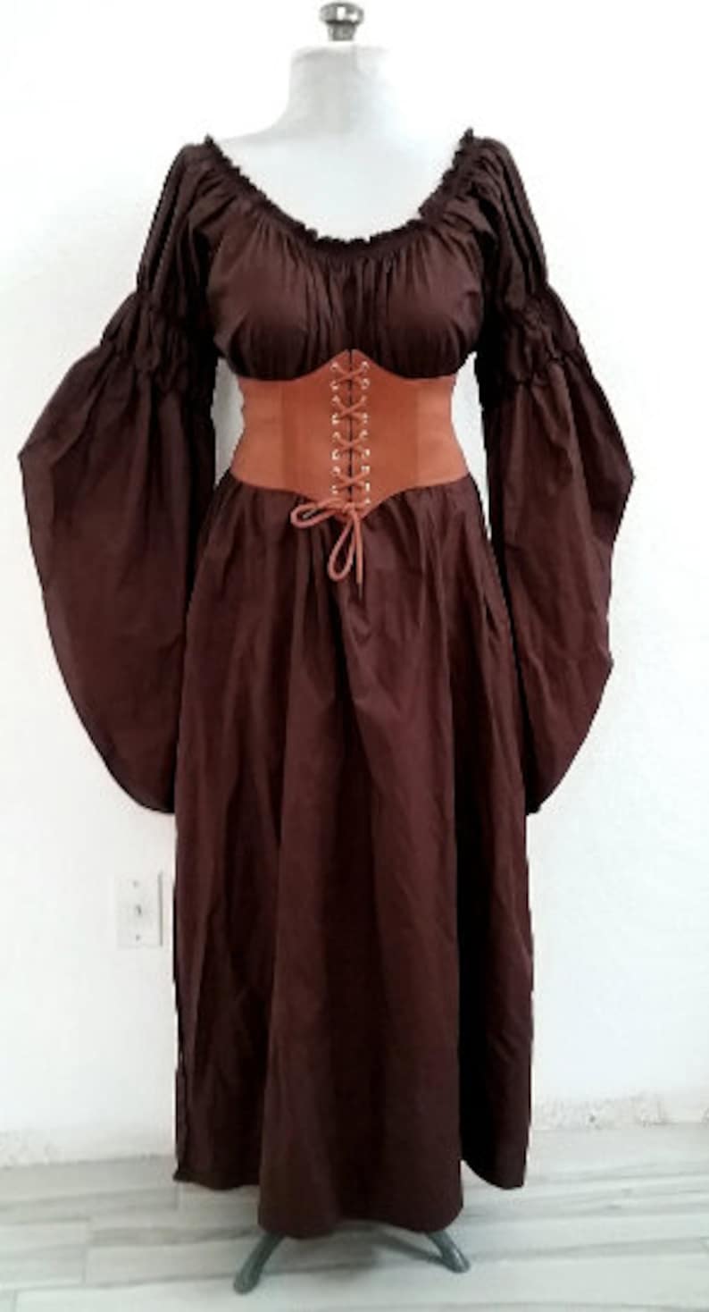 K&ouml;nnte beinhalten: Ein braunes Kleid im mittelalterlichen Stil mit langen, flie&szlig;enden &Auml;rmeln und einem eng anliegenden braunen Korsett. Das Kleid hat einen Rundhalsausschnitt und einen weiten Rock. Das Korsett ist vorne mit einer braunen Kordel geschn&uuml;rt.