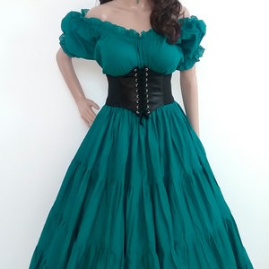 May include: A teal green dress with a black corset belt and a floral crown. The dress has a ruffled skirt and a fitted bodice.
