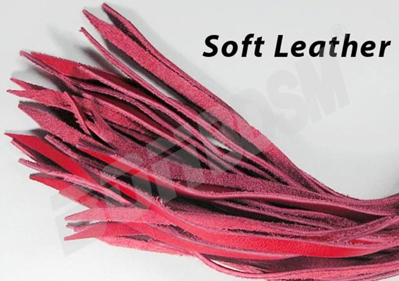 May include: A close-up of a bundle of soft, red leather strips. The strips are arranged in a fan shape and have a slightly textured surface. The text "Soft Leather" is visible in the upper right corner of the image.