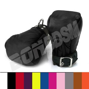 May include: Pair of black leather restraints with a metal ring and buckle. The restraints are designed to be worn on the hands.