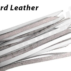 May include: A close-up of a bundle of white leather strips with a textured surface. The strips are arranged in a fan shape, with the ends of the strips pointing towards the top of the image. The text "Hard Leather" is visible at the top of the image.