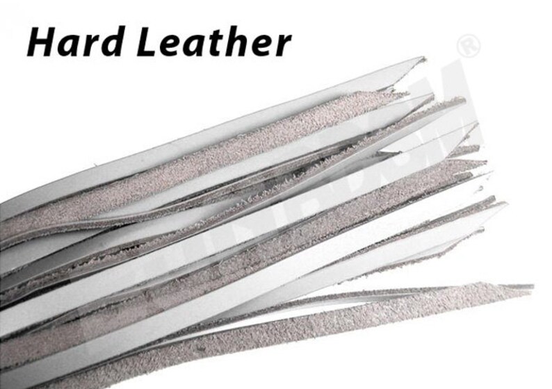 May include: A close-up of a bundle of white leather strips with a textured surface. The strips are arranged in a fan shape, with the ends of the strips pointing towards the top of the image. The text "Hard Leather" is visible at the top of the image.