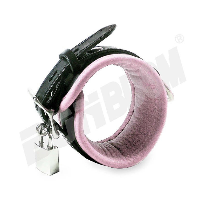 May include: Black leather cuff with a pink padded interior and a silver padlock.
