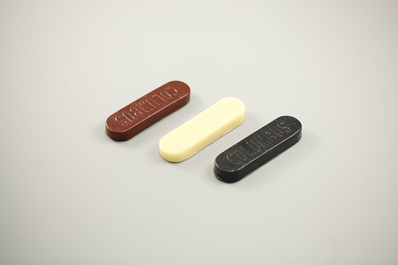 May include: Three shoe polish bars, one brown, one white, and one black. The brown bar says "SHOE POLISH", the white bar says "COLLONIL", and the black bar says "COLLONIL".