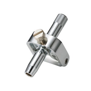 May include: A silver metal circle cutter tool with a knob on the top and a screw on the side. The tool is used to cut circles in materials such as paper, fabric, and leather.