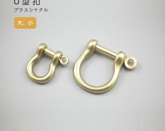 May include: Two gold-colored U-shaped metal clasps, one larger than the other. The text "U型 扣" and "ブラスジャングル" is visible in the image. The text "大, 小" is also visible in the image.