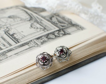 Small Vintage openwork silver tone clip-on earrings with garnet glass