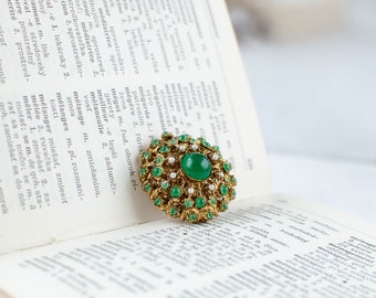 Green vintage round filigree openwork brooch with glass cabochon