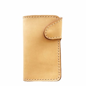 May include: A light brown leather wallet with a flap closure and stitched edges.