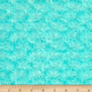 May include: A turquoise blue fabric with a swirling, textured pattern resembling small, overlapping circles.