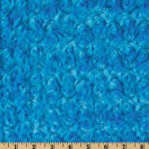 May include: Abstract blue and white swirl pattern fabric. The fabric has a soft, fuzzy texture.