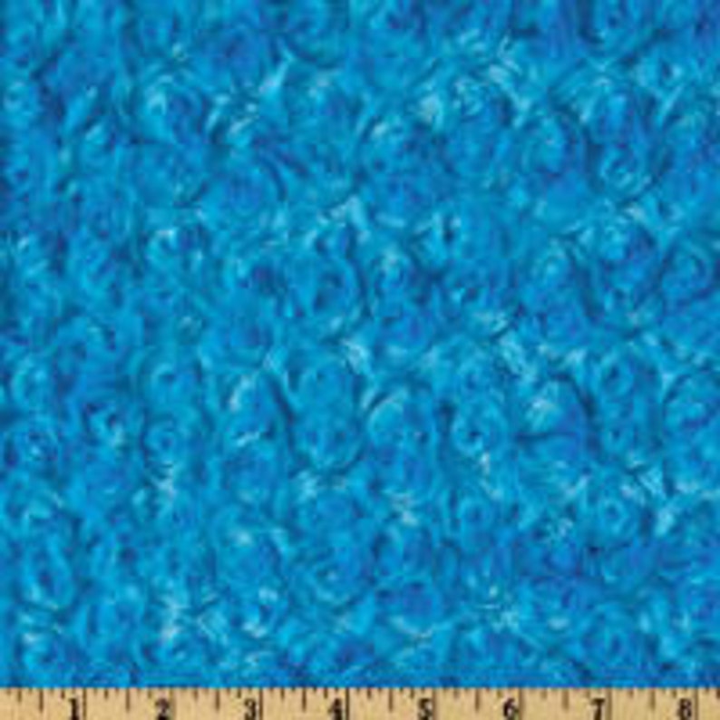 May include: Abstract blue and white swirl pattern fabric. The fabric has a soft, fuzzy texture.