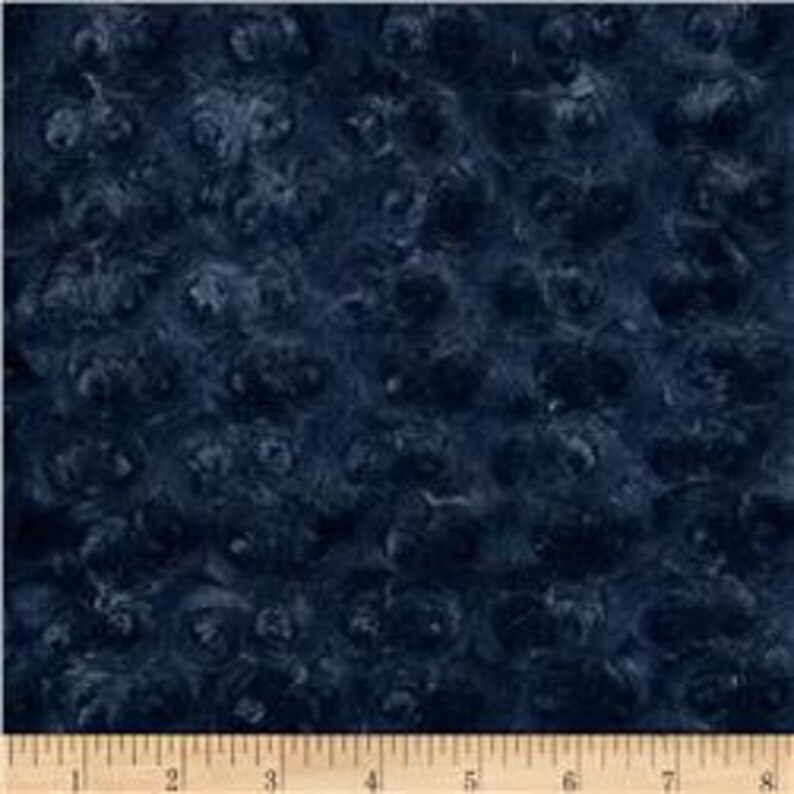 May include: Blue fabric with a swirling, marbled pattern. The fabric has a textured, almost fuzzy surface.
