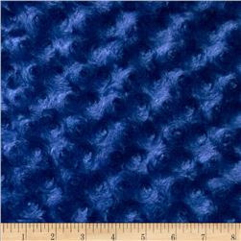 May include: Blue swirl patterned minky fabric. The fabric has a soft, fuzzy texture.