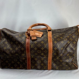 Two replica Louis Vuitton monogrammed duffle bags; 530-136 - R.H. Lee & Co.  Auctioneers