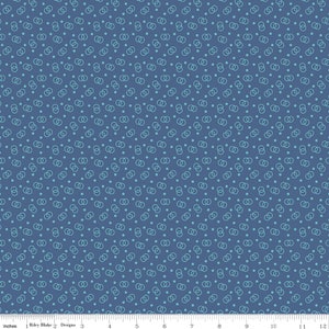 May include: Blue fabric with a repeating pattern of interlocking circles and small dots in a lighter shade of blue. The fabric is marked with inches and the text "Riley Blake Designs".