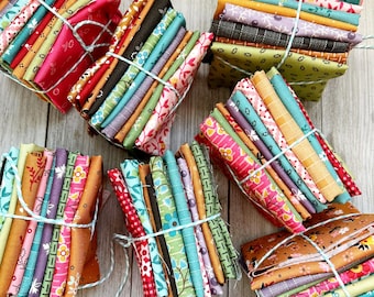 May include: Several bundles of patterned fabric squares, secured with twine. The fabric displays floral and geometric designs in a variety of colours, including red, pink, green, blue, and brown. Perfect for quilting and craft projects.