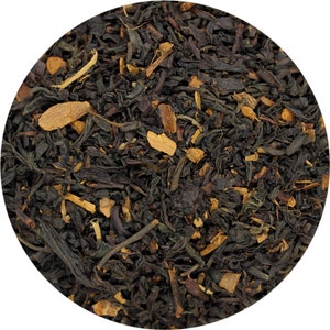 May include: Close-up of black tea leaves with cinnamon pieces. The tea blend is a dark brown color and has a rough texture.