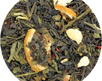 May include: Close-up of loose leaf tea blend with green tea leaves, dried orange and white pieces. The tea blend has a variety of textures and colors, including dark green, light green, orange, and white. The tea is presented in a circular shape.