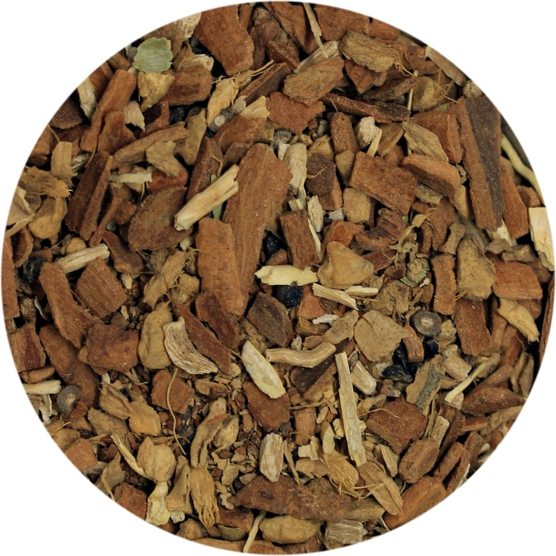 May include: Close-up of a circular arrangement of dried herbs and spices. The image features a mix of brown, tan, and green pieces, including what appears to be bark, roots, and leaves. The texture is rough and natural, suggesting a blend for culinary or medicinal use.