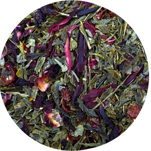 May include: A close-up of a blend of green, red, and purple tea leaves. The tea leaves are loose and ready to be brewed.