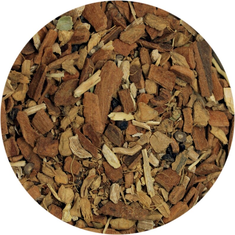 May include: Close-up of a circular arrangement of dried herbs and spices. The image features a mix of brown, tan, and green pieces, including what appears to be bark, roots, and leaves. The texture is rough and natural, suggesting a blend for culinary or medicinal use.