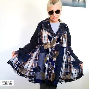May include: A patchwork jacket with a unique design. The jacket features a mix of plaid, floral, and solid fabrics in navy, brown, and white. It has a lace trim and is labeled "Designed by MARTINELLI".
