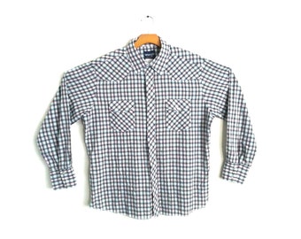 May include: A long-sleeved plaid shirt with a button-down collar and two chest pockets. The shirt is in a blue, white, and pink plaid pattern.