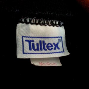 May include: White tag with blue text that reads "Tultex" and "Medium" in pink text.