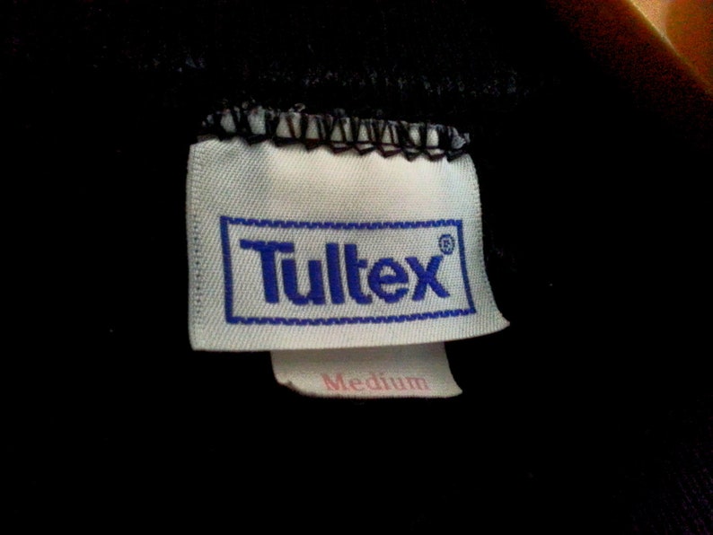 May include: White tag with blue text that reads "Tultex" and "Medium" in pink text.