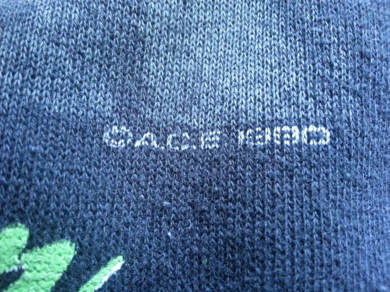 May include: Close-up of a dark blue fabric with the text "C.A.C.I.E.S. KOREA" printed in white.