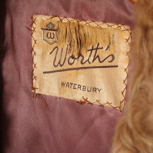 May include: A brown fur coat with a label that reads "Worth's Waterbury".