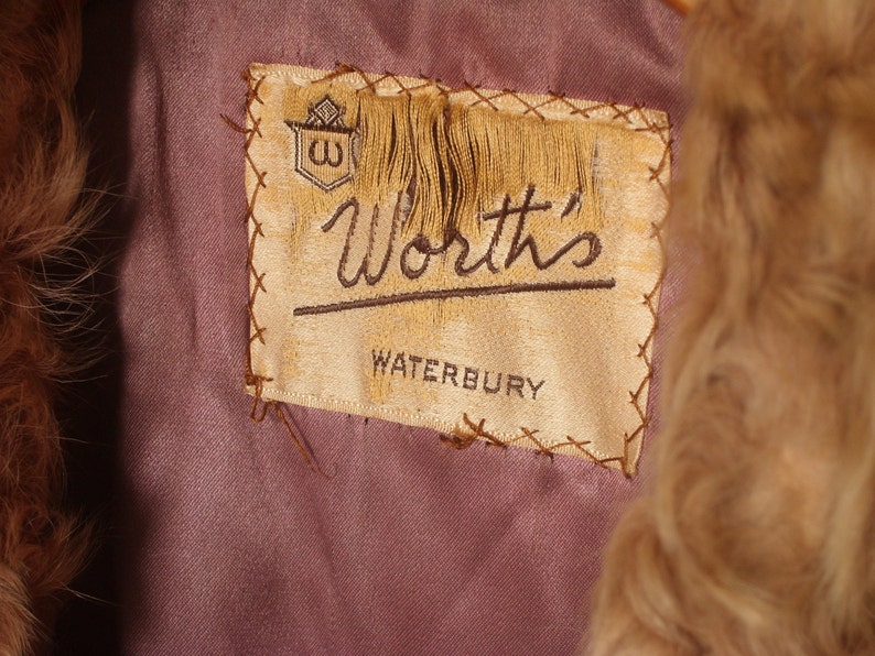 May include: A brown fur coat with a label that reads "Worth's Waterbury".